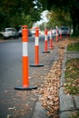 A line of orange and white traffic bollards. Royalty Free Stock Photo