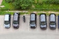 Line from parked cars and one motorcycle standing on parking place for vehicle, top view