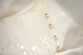 Line of pearl buttons on a white wedding dress Royalty Free Stock Photo