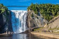 Line of People at Bottom of Montmorency Falls Royalty Free Stock Photo