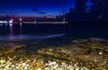 Line pier with lights and a beacon on a background of clouds night beach, Crete, Gouves Royalty Free Stock Photo