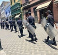 Police walking with Policia body shields and armor