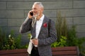 On the line. Portrait of happy, successful middle aged businessman in stylish suit smiling while talking on the phone Royalty Free Stock Photo