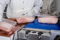 Line for the production of semi-finished meat products.Meat processing in food industry.Packing of meat slices in boxes Royalty Free Stock Photo