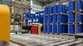 Line production used for filling chemicals into 200 liter drums. Blue barrel chemical drums are stacked on wooden pallets inside Royalty Free Stock Photo