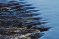 A line of rocks in hard flowing stream in Finnish rapids