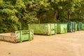 Line of rusty containers near the green trees Royalty Free Stock Photo