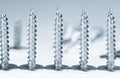 Line of silver screws toned grey Royalty Free Stock Photo