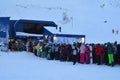 A line of skiers and snowboarders on the ski lift complex Big Woodyavr (Kirovsk, Russia) Royalty Free Stock Photo