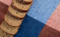 A line of slices of brown bread on a tablecloth Royalty Free Stock Photo