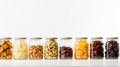A line of snack-friendly glass jars holding various dried fruits. on white background Royalty Free Stock Photo