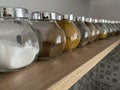 Line of spices in glasses in modern kitchen