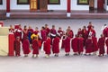 Line of Tibetan monks in front of Rumtek Monastery for welcoming high level monk near Gangtok. Sikkim, India. Royalty Free Stock Photo