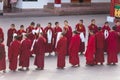 Line of Tibetan monks in front of Rumtek Monastery for welcoming high level monk near Gangtok. Sikkim, India