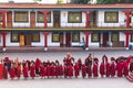 Line of Tibetan monks in front of Rumtek Monastery for welcoming high level monk near Gangtok. Sikkim, India. Royalty Free Stock Photo