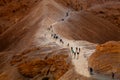 Line of tourists climbed on the Masada fortress rock