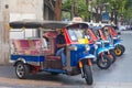 Line of tuktuks with driver on Bangkok street