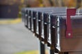 line up of black mailboxes with first mail box with red flag up signifying got mail for U.S. mail Royalty Free Stock Photo