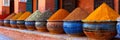 A line-up of pots holding an assortment of different spices