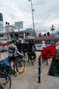 On the line waiting for the turn the bicycle rider to go on board the ship.