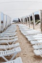 Line from white chaise-longues on beach Royalty Free Stock Photo