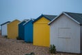 A line of wooden beach huts on a pebble beach Royalty Free Stock Photo