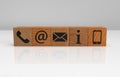 Line of wooden dice with contact symbols and white background