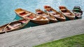 Line of Wooden Rowboats Tied to Dock