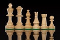 Line of wooden white chess pieces isolated at dark background Royalty Free Stock Photo