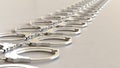 Linear Array of chrome Handcuffss on a Light Gray Surface Royalty Free Stock Photo