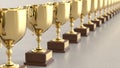 Linear Array of Gold Trophys on a Light Gray Surface Royalty Free Stock Photo