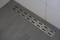 Linear floor level shower