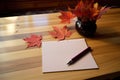 lined note cards and pen on a maple table