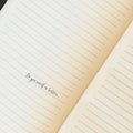 Lined notebook with a handwritten motivational phrase. Royalty Free Stock Photo