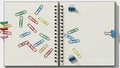 With lined pages features various colored paperclips scattered Royalty Free Stock Photo