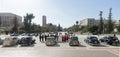 Lined up, American classic cars then wedding party and row of photographers