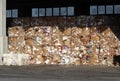 Lined up stacks of cardboard and waste paper in a recycling plant storage