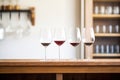 a lined up trio of red wine glasses with varying levels Royalty Free Stock Photo