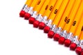 A row of yellow pencils with pink erasers isolated on white with copy space Royalty Free Stock Photo