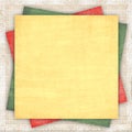 Linen background with a multi-coloured paper Royalty Free Stock Photo