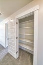 Linen closet of house with wide shelves for storing organization and white door Royalty Free Stock Photo