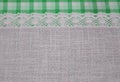 Linen cloth textile with lace lacy ribbon and border of green tartan pattern. Royalty Free Stock Photo