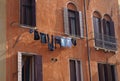 The linen dried outside the windows - Venice, Italy. The wall with windows of the medieval house on the canal. Royalty Free Stock Photo