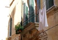 The linen dried outside the windows - Venice, Italy. The wall with windows of the medieval house on the canal. Royalty Free Stock Photo