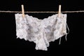 Linen drying on a string. Sexy women's panties pinned to a string