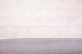 Linen light gray tablecloth lies on a white wooden background. Horizontally. View from above. Copy spaes