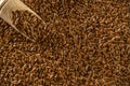 Linen seed, flaxseed - organic food background. Brown flax, linseed in wooden scoop for oil isolated dark stone. Vegan