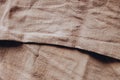 Linen table cloth texture with deep shadows in brown color. Coutry cozy home fabric atmosphere. Top view. Copy space on background Royalty Free Stock Photo