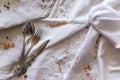 Linen tablecloth and towels lie chaotically, in the corner of cutlery: spoon, fork, knife. Royalty Free Stock Photo