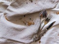 Linen tablecloth and towels lie chaotically, in the corner of cutlery: spoon, fork, knife. Royalty Free Stock Photo